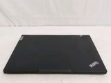 a black laptop on a white surface with a white background