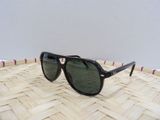 a close up of a pair of sunglasses on a woven basket