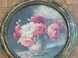 a picture of a painting of flowers in a vase on the floor
