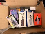 a cardboard box filled with electronic items on the floor