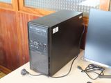 a desktop computer sitting on a desk next to a computer monitor