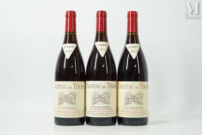 three bottles of red wine sitting on top of a white table
