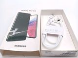 a box with a phone and a charger in it