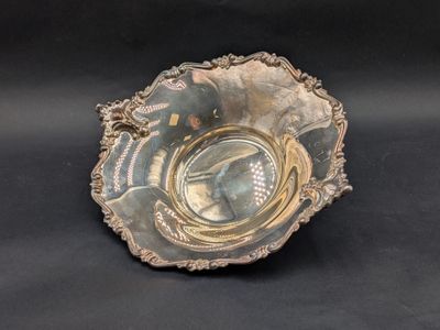 a silver bowl with a picture of a woman on it