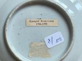 a white plate with a tag on it on a table