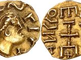 a gold coin with an image of a woman on it