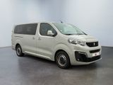the white van is parked in a large room with a black floor