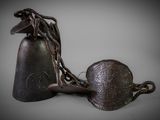 two bells that are chained to a chain