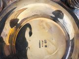 a silver plate with a picture of a man on it