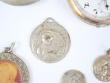many different pieces of silver and gold on a white surface
