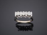 a diamond five stone ring set in 18k white gold
