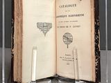 a book that is open on a table with a pen and paperclip