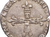 an old silver coin with a cross on it