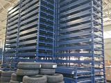 several stacks of tires are stacked on pallets in a warehouse