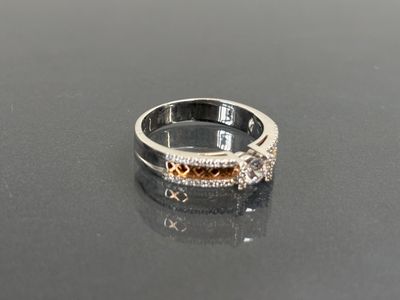 a diamond ring on a table with a black surface