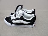 a pair of black and white shoes on a white surface