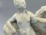 marble statue of a woman on a horse with a bird in her hand