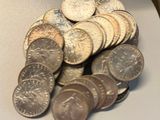 a pile of coins sitting on a plate on a table