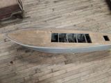 a small boat that is sitting on a wooden floor