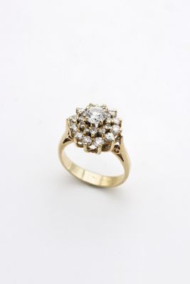 a close up of a diamond ring on a white surface
