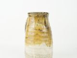 a brown and white vase sitting on a white surface