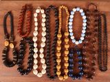 a lot of beads that are on a wooden board
