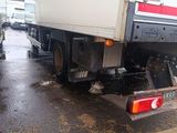 two trucks that are parked on the side of the road
