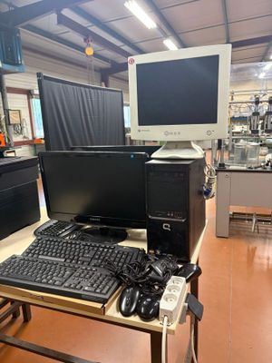 two computer monitors and a keyboard on a table