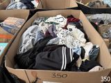 a cardboard box filled with clothes and other items