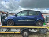 a blue car on the back of a flatbed truck