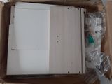 a white refrigerator sitting inside of a box on the floor