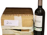 a bottle of wine next to a cardboard box with a label on it