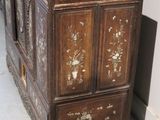 a very old wooden cabinet that is in a room