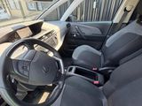 the interior of a small car with a steering wheel and dashboard