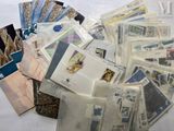 a pile of stamps and envelopes sitting on a table
