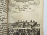 an open book with a drawing of a castle in the middle