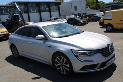a white car that is parked in a parking lot
