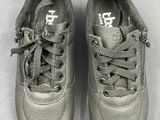 pair of gray shoes on a white surface with a white background