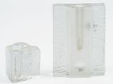 two pieces of ice sitting next to each other on a white surface