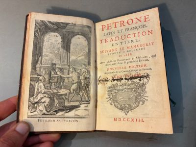 Quelqu'un tient à la main un livre sur lequel figure la photo d'un homme.