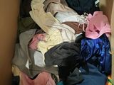 a box full of clothes that is sitting on the floor