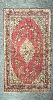 un tapis rouge et or orné d’un motif en médaillon