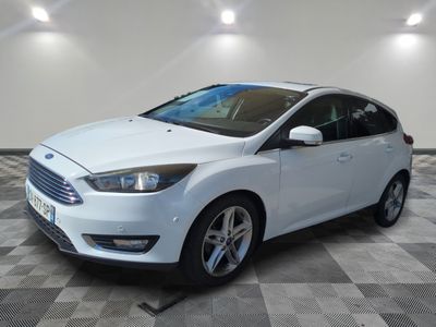 the white ford focus is parked in a room with a checkered floor