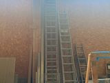 a ladder that is going up the side of a building