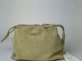 beige sued pouch with a tag on it sitting on a white surface