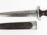 two knifes are laying side by side on a white surface