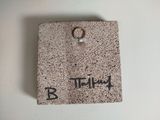 a picture of a stone plaque with a ring on it