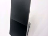a cell phone that is sitting on top of a stand