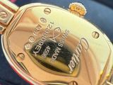 a close up of a gold watch in a red box