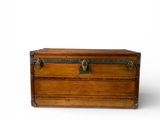 an old wooden trunk sitting on top of a white surface